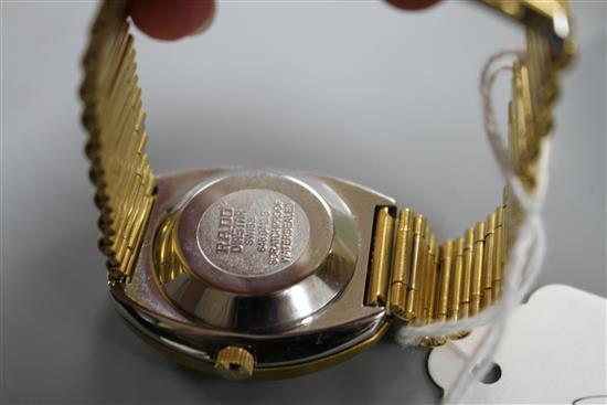 A gentlemans gilt steel Rado Diastar automatic wrist watch, with red stone set markers and textured dial, on Rado bracelet.